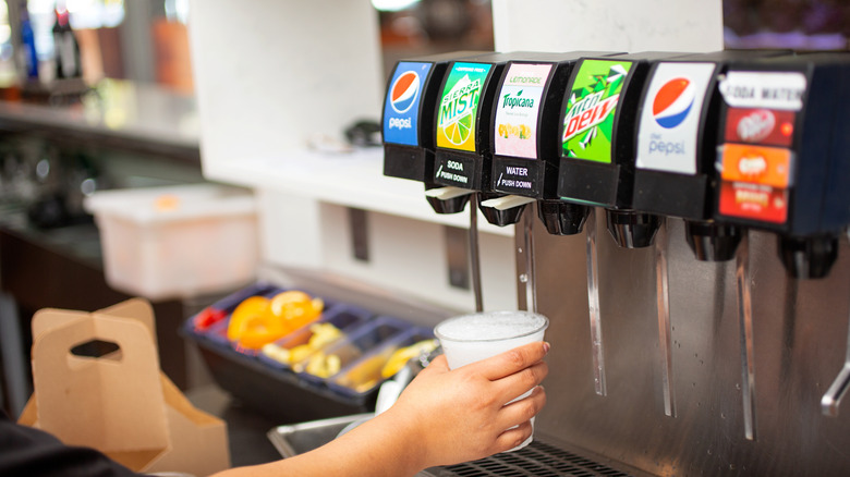 A person getting a fountain drink