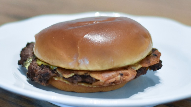 A cheeseburger on a white plate