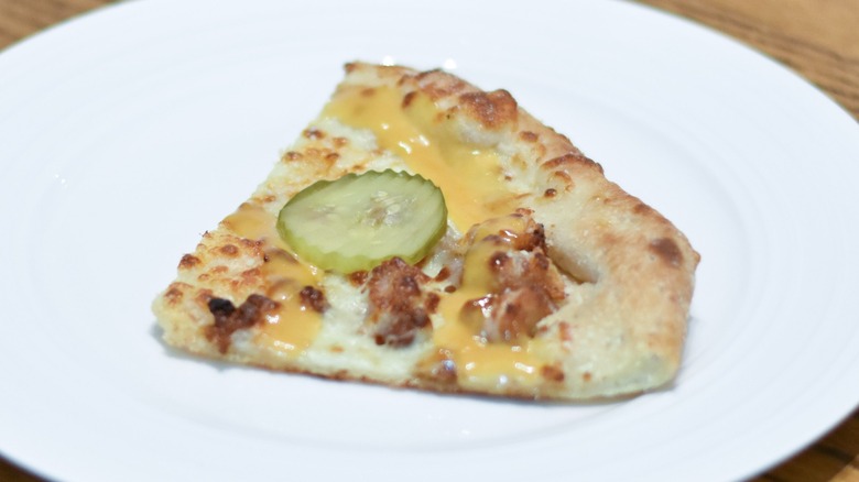 A slice of Chick-fil-A pizza on a white plate