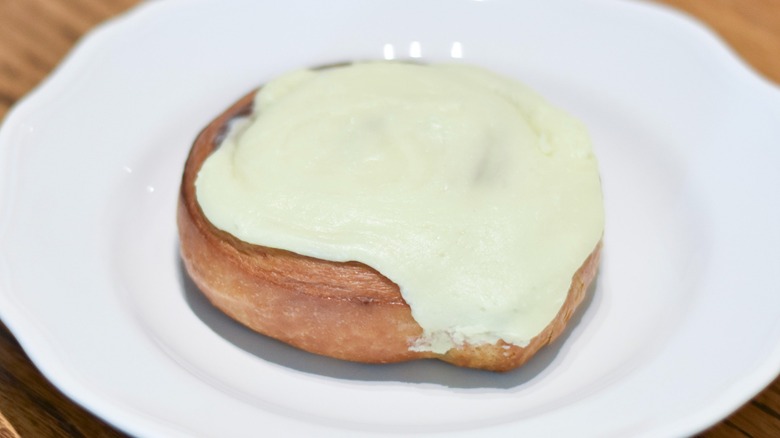 A cinnamon roll on a white plate