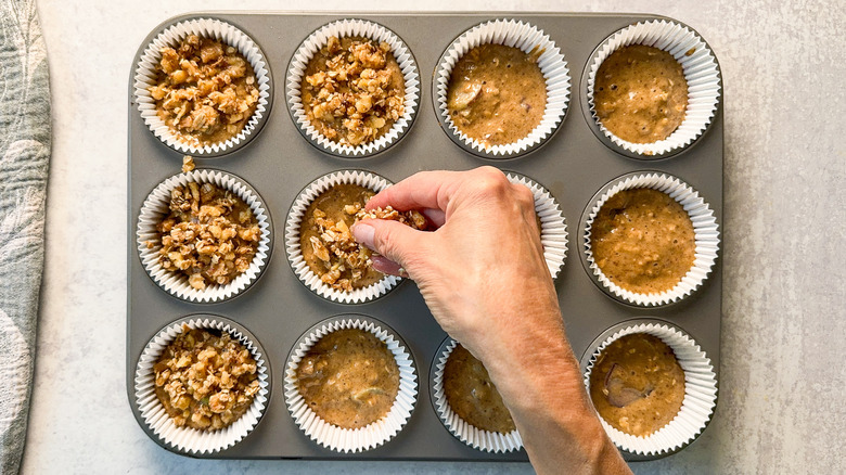 Topping rhubarb and cardamom oat muffin batter with walnut oat streusel