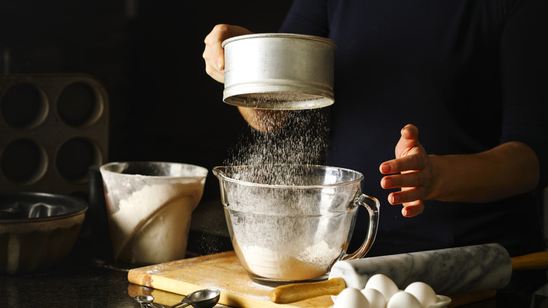 Woman sifting flour