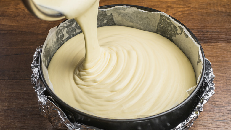 Cake batter being poured into a tin