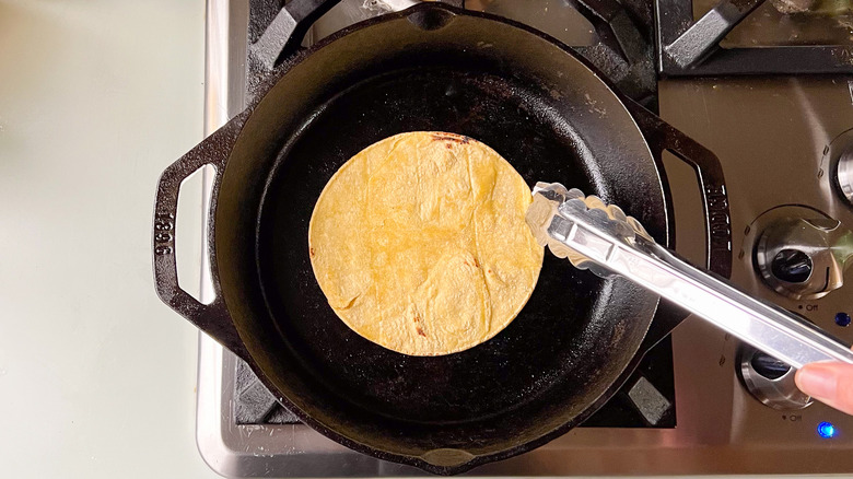 Tortilla in cast iron skillet on stove top