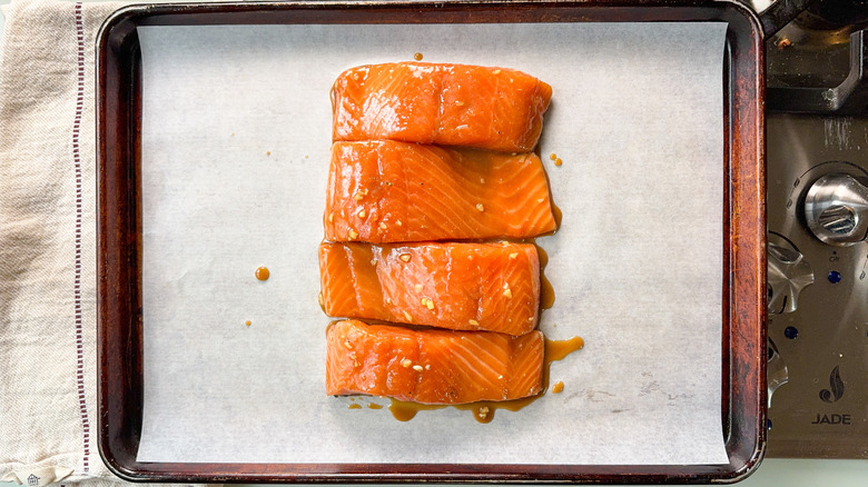 Miso maple marinated salmon fillets on parchment lined baking sheet