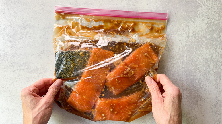 Skin-on salmon fillets in a ziplock bag with miso maple marinade