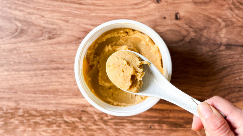 White miso paste on spoon and in tub