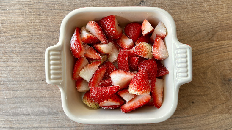 chopped strawberries in white baking pan