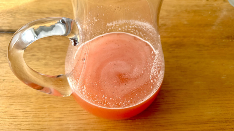 pink lemonade in a glass pitcher