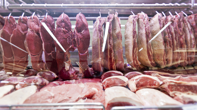 Cuts of beef hanging in a butcher shop