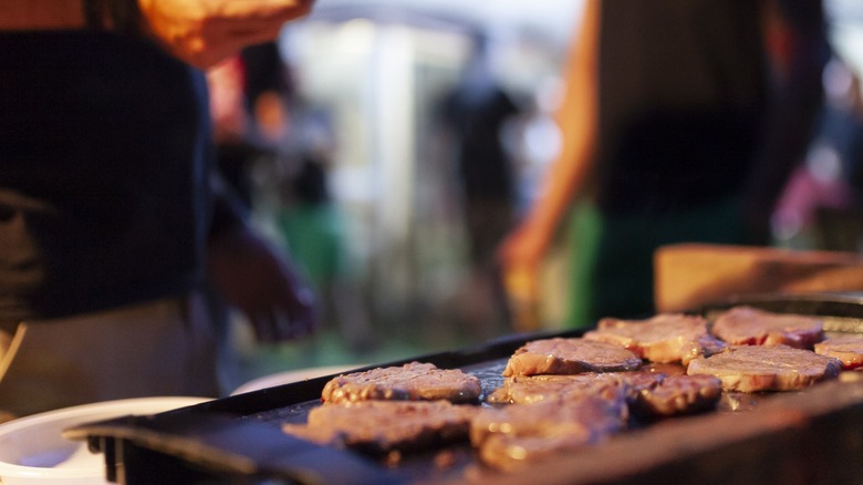 friends around outdoor griddle