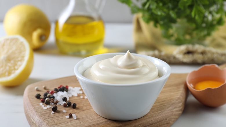 Small bowl of mayo surrounded by the condiment's ingredients