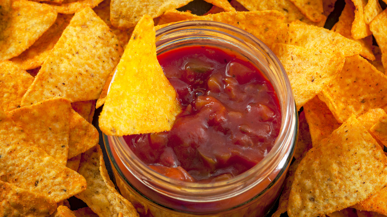 chips around jar of salsa