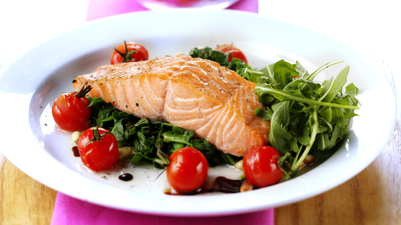 salmon of bed of greens and tomatoes