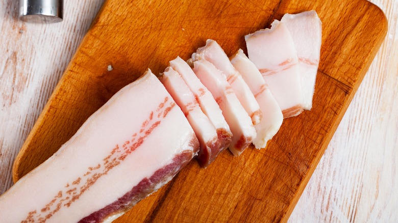 Sliced salt pork on a cutting board