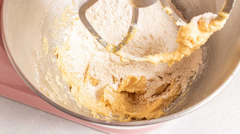 Flour added to cookie batter in a bowl