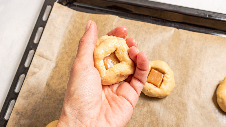 hand holding cookie dough