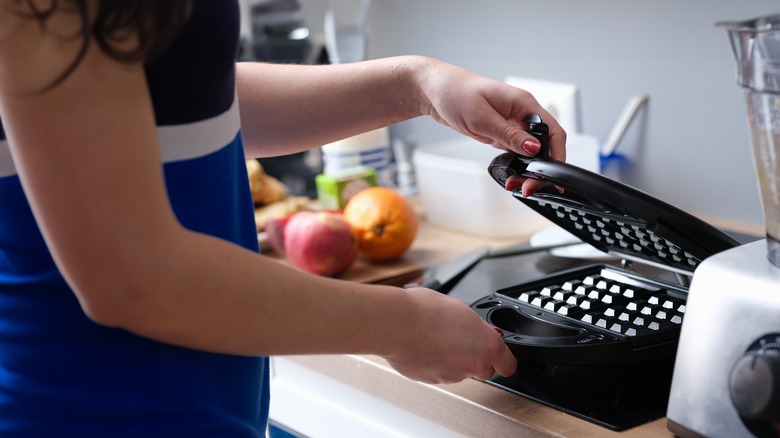 Person using waffle maker