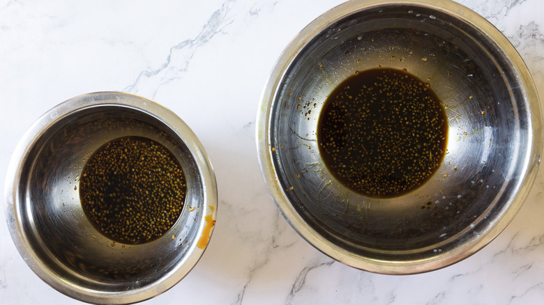 two metal bowls with marinade