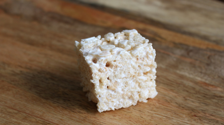 Single Rice Krispie treat on wood surface