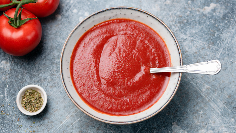 Bowl of tomato sauce with spoon