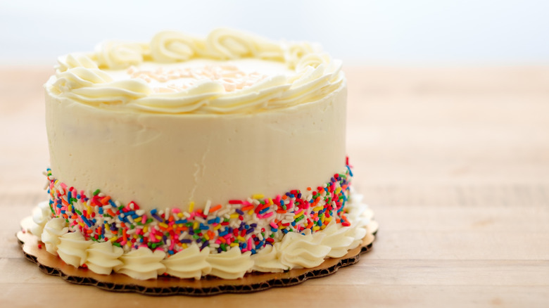 Birthday cake with white icing and sprinkles