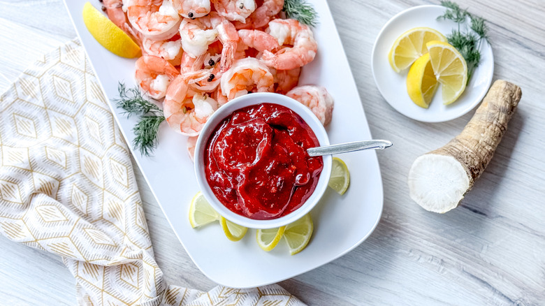 Scandinavian-inspired lingonberry cocktail sauce with chilled cooked shrimp, lemons, and horseradish root