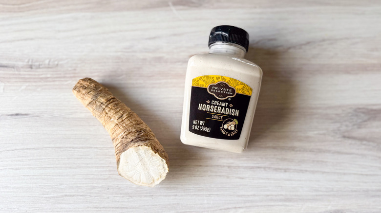 Fresh horseradish root and bottle of creamed horseradish