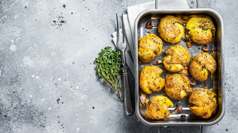 Roasted smashed potatoes in pan