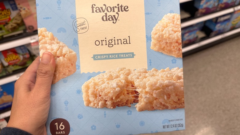 person holding a box of Favorite Day crispy rice treats in Target