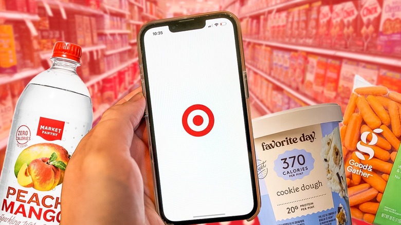 hand holding a smartphone with Target app and Target items in the background