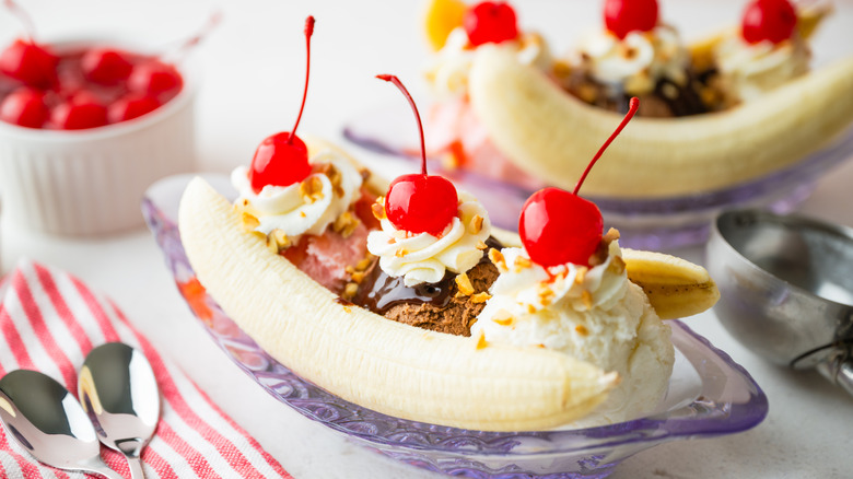 Banana split with cherries and whipped cream