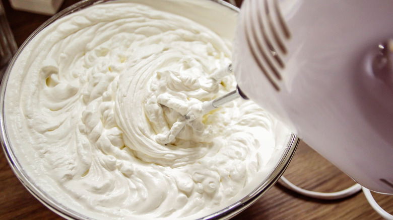 Whipping cream whipped with an electric hand mixer