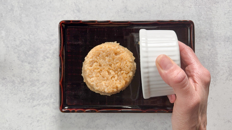 Unmolding rice in a ramekin onto a plate