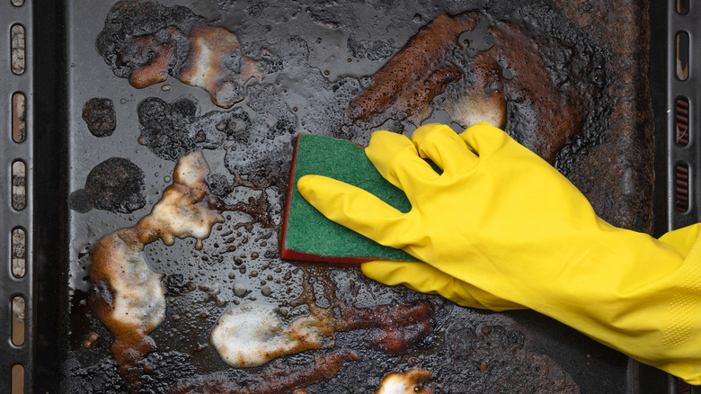 cleaning a dirty sheet pan