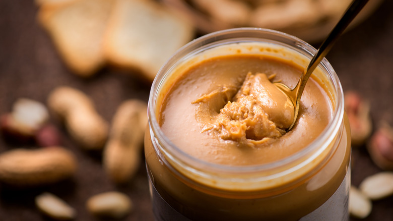 Peanut butter in a jar with a spoon