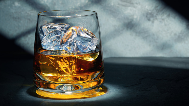 A glass of whiskey with ice