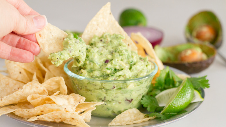 A bowl of guac and chips