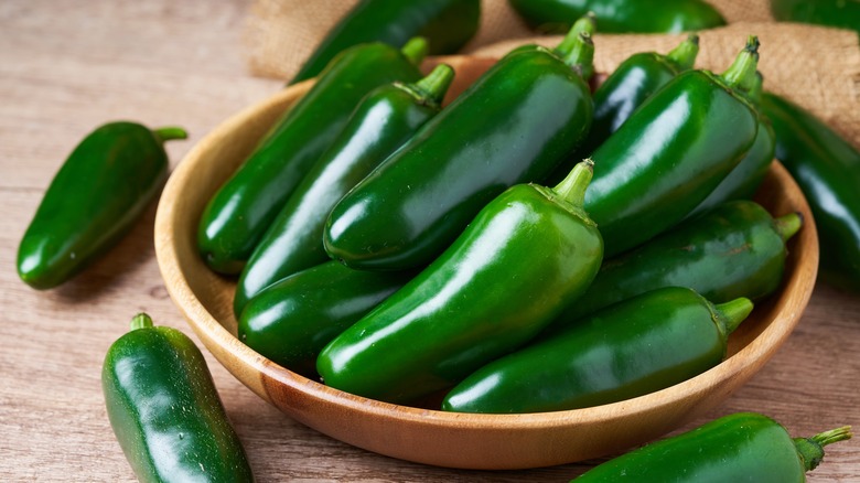 a bowl of whole jalapeños on the counter