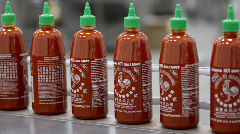 row of Sriracha bottles