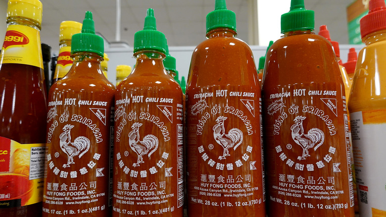 four bottles of Sriracha