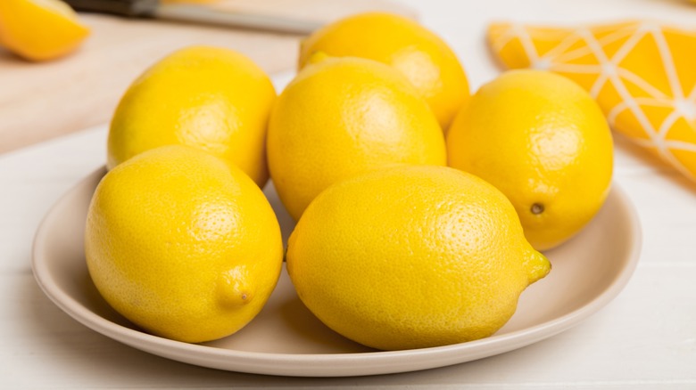 Fresh ripe lemons on plate