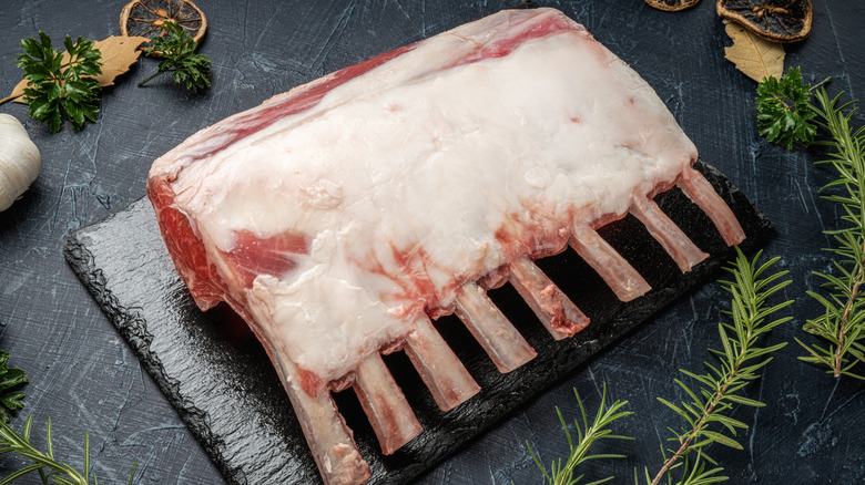 A raw rack of lamb with the fat intact