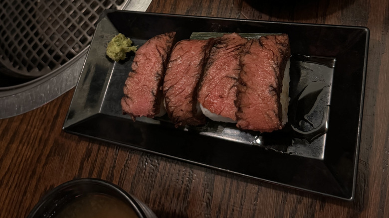 slices of steak on a black plate