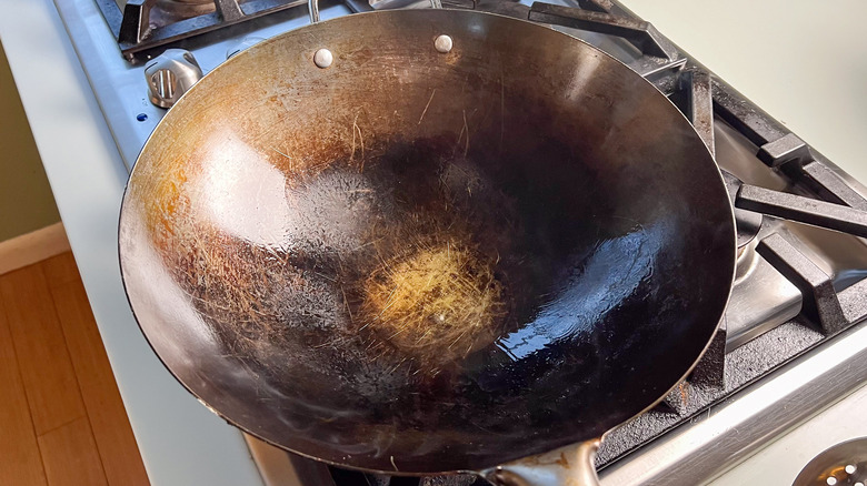 Heating oil in wok on stove