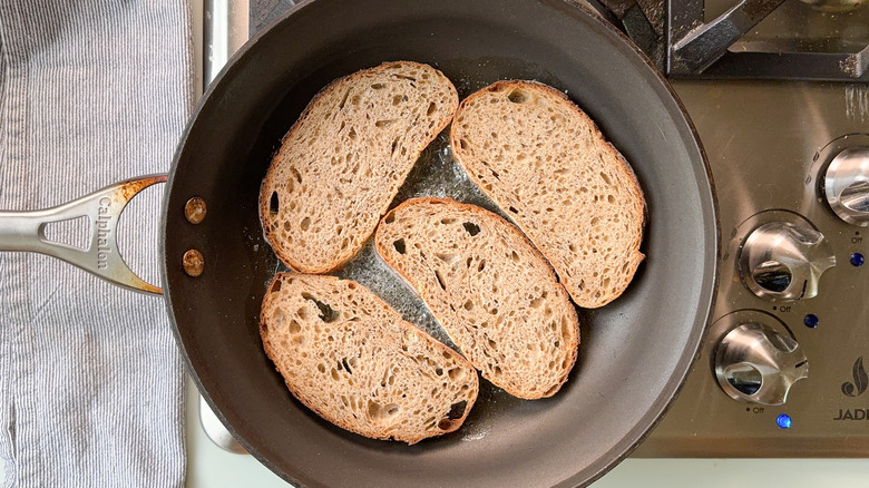 Rye bread slices in skillet on stovetop