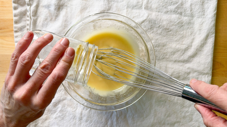 Whisking oil into mayonnaise