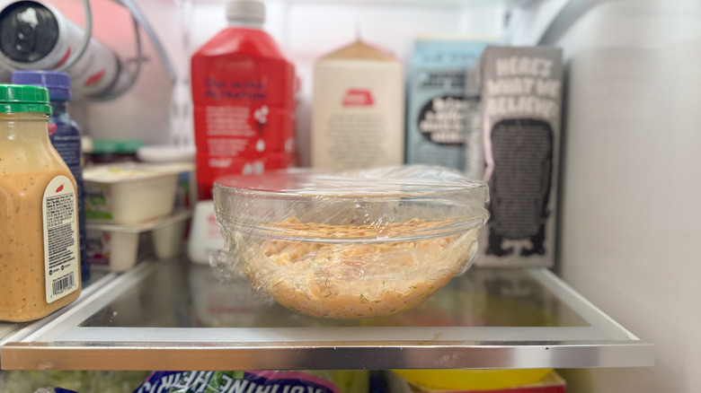 Shrimp salad in glass bowl in refrigerator