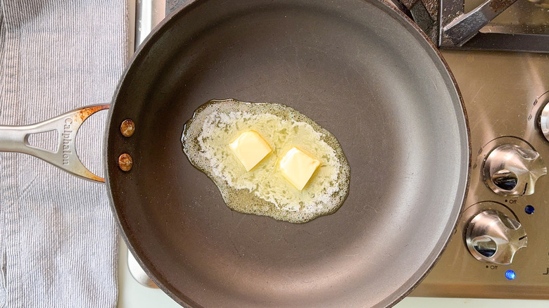 Butter melting in skillet on stovetop