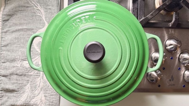 Green covered pot on stovetop